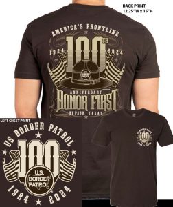 A brown centennial T-shirt with a graphic print commemorating the 100th anniversary of the US Border Patrol. The design includes the text 'Honor First', the US flag, and the years 1924 and 2024.
